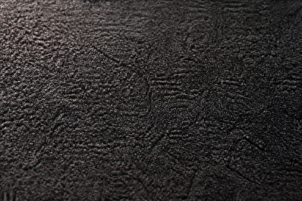 Macro view of dense dark automotive carpet fibres