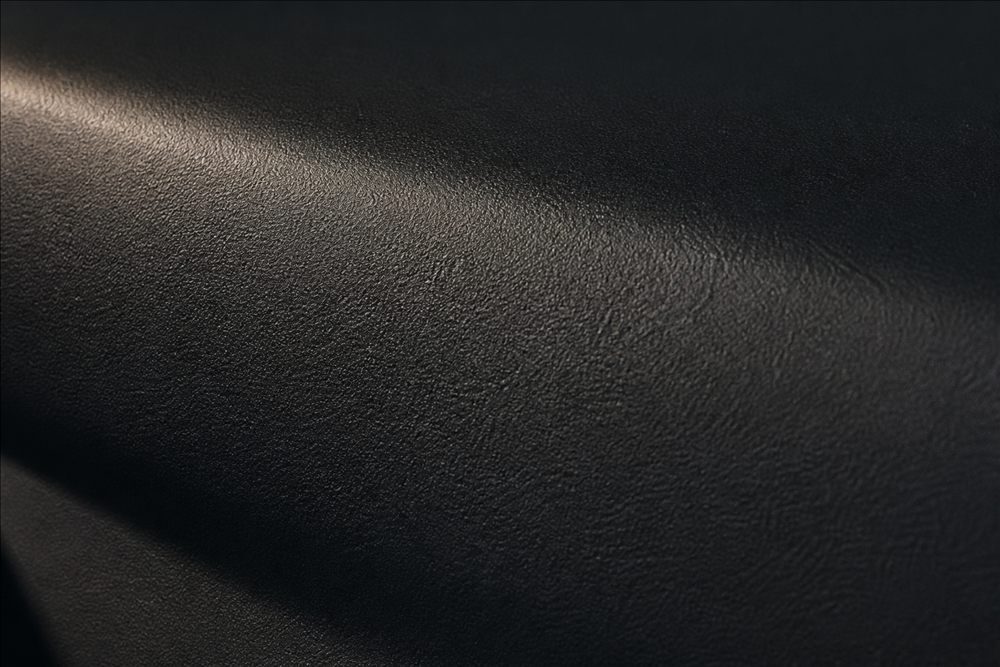 Macro view of grain-textured matte automotive plastic