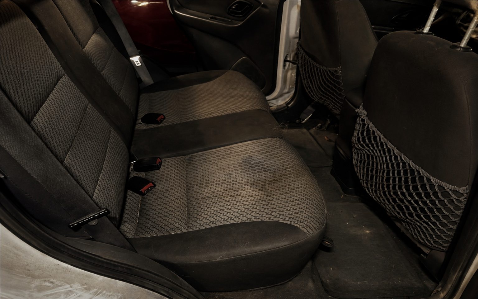 A soiled rear seating area before a deep interior detail