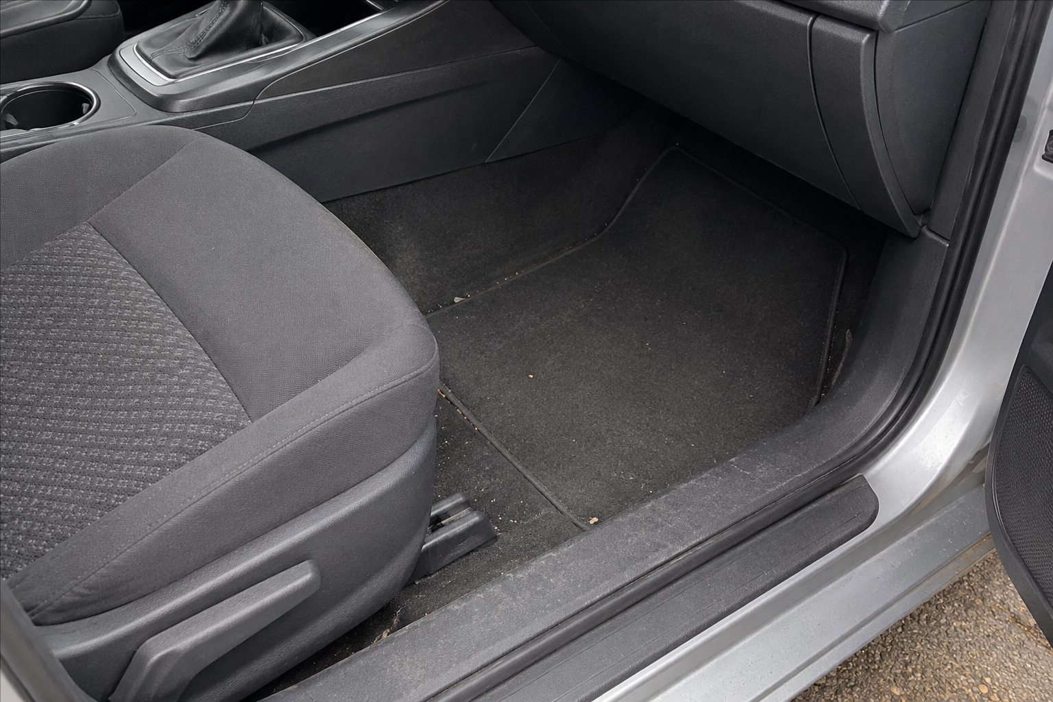 A lightly soiled front passenger area before a maintenance interior clean